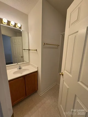 a bathroom with a sink and mirror with toilet