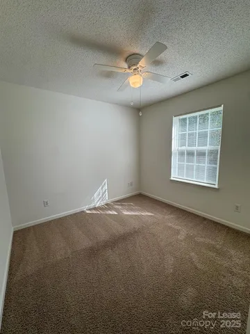 an empty room with a empty space and windows