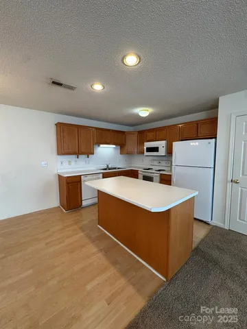 a kitchen with stainless steel appliances granite countertop a stove and a sink