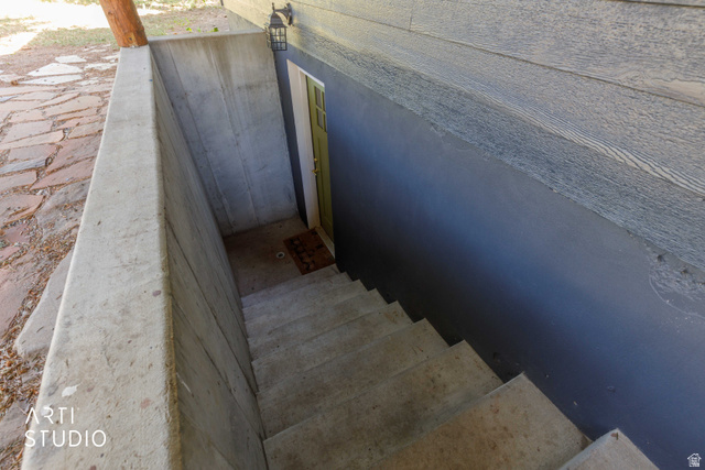 2807 North Ogden Canyon Road Eden, UT 84310 - Photo 53 of 72 Separate entry for basement. Concrete outdoor stairs descending to a recessed entry with a green door