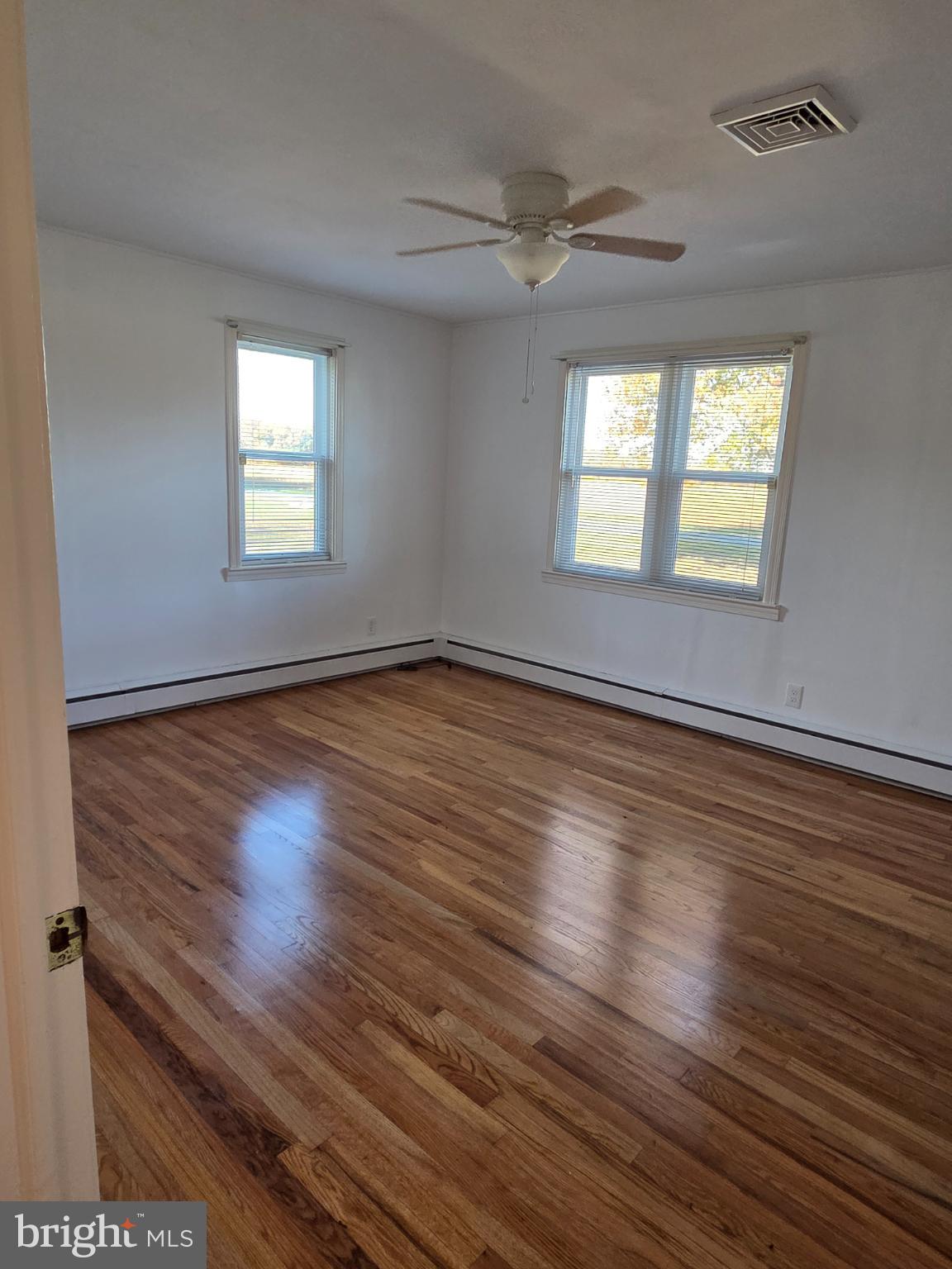 588 Gum Bush Road Townsend, DE 19734 - Photo 11 of 22 an empty room with wooden floor and windows