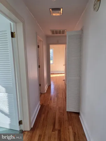 a view of hallway with wooden floor