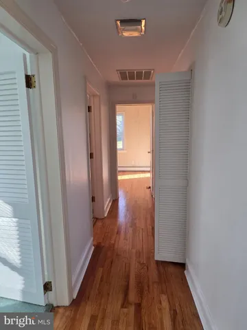 a view of hallway with wooden floor