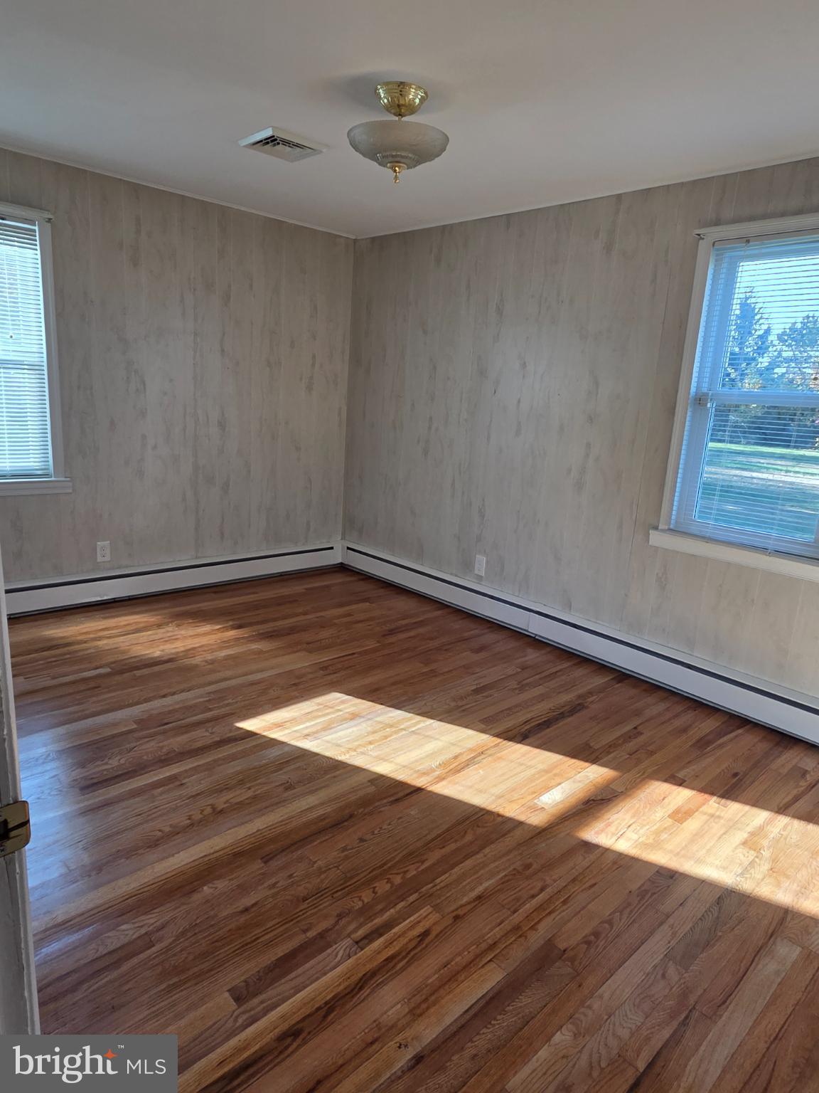 588 Gum Bush Road Townsend, DE 19734 - Photo 9 of 22 a view of an empty room with wooden floor and a window