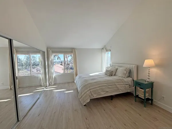 a bedroom with a bed and a lamp next to a window