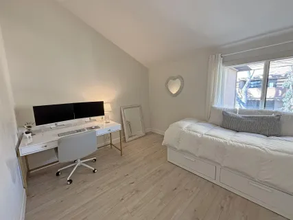 a bedroom with a bed and a desk