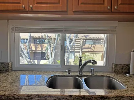 a kitchen sink sitting next to a window