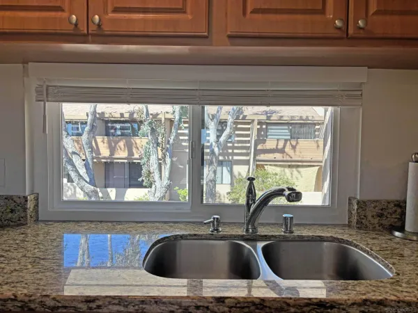 a kitchen sink sitting next to a window