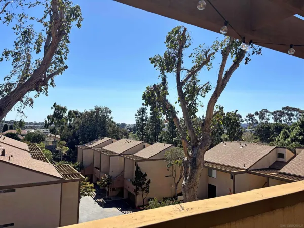 a view of a house with a tree beside it