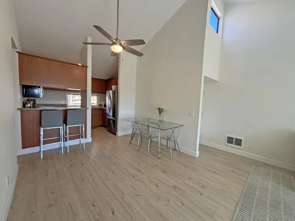 a view of a room with wooden floor and chairs