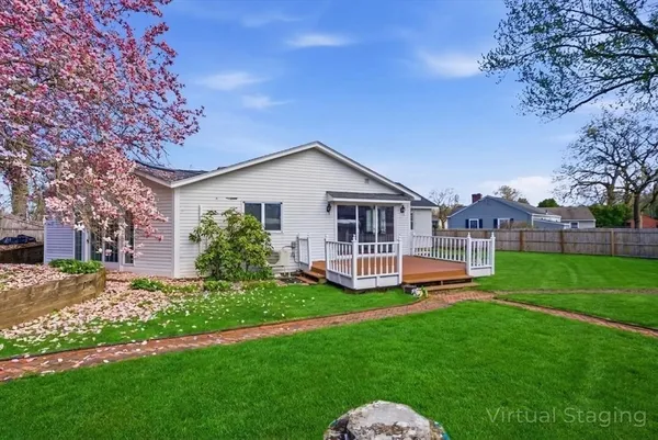 a front view of a house with a yard table and chairs