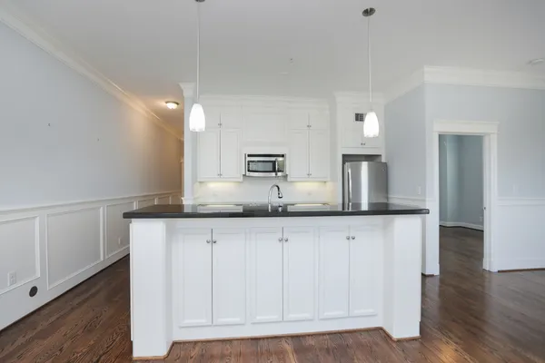 a kitchen with granite countertop a sink and a stove