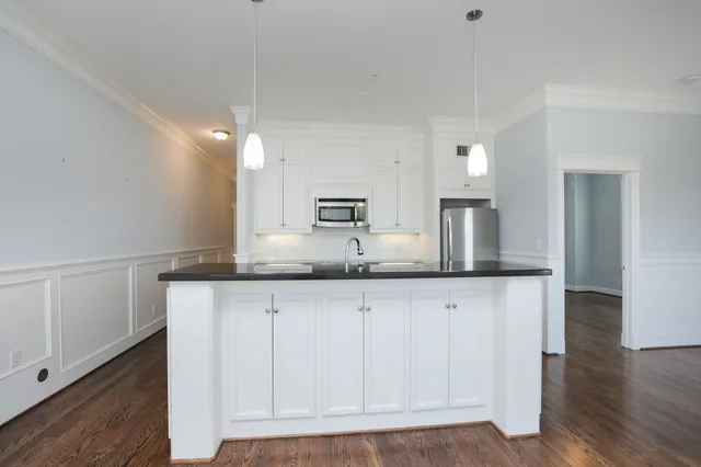 a kitchen with granite countertop a sink and a stove