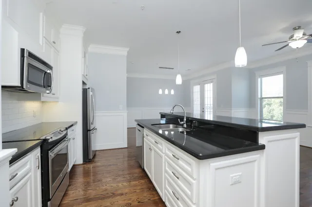 a kitchen with stainless steel appliances granite countertop a sink stove and refrigerator