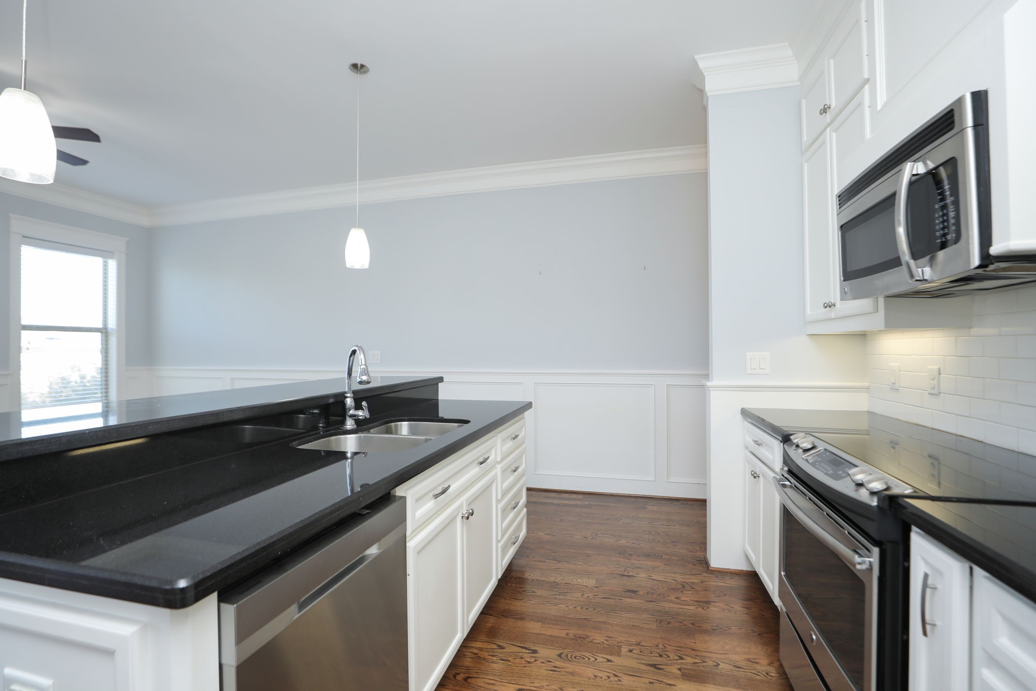 2802 Morrison Street, Unit 201 Houston, TX 77009 - Photo 16 of 50 a kitchen with stainless steel appliances granite countertop a sink stove and microwave