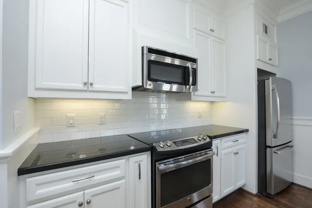 a granite counter a sink and a window