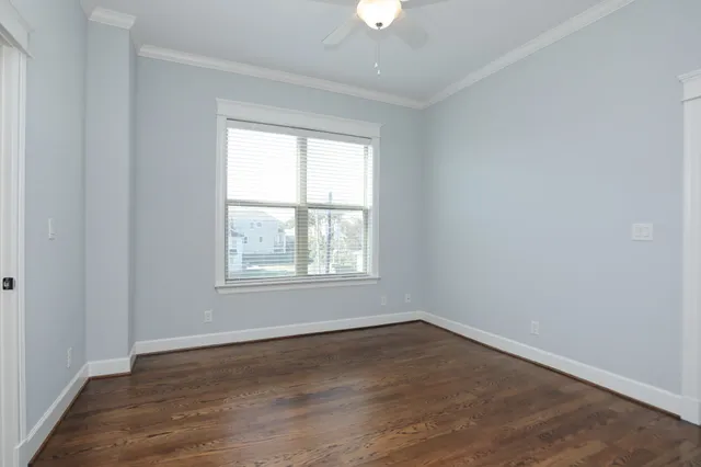 an empty room with closet and wooden floor
