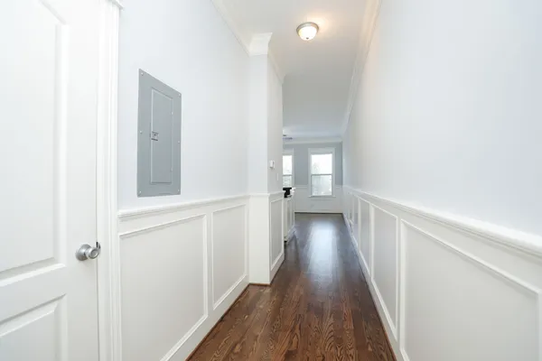 a view of a room with wooden floor