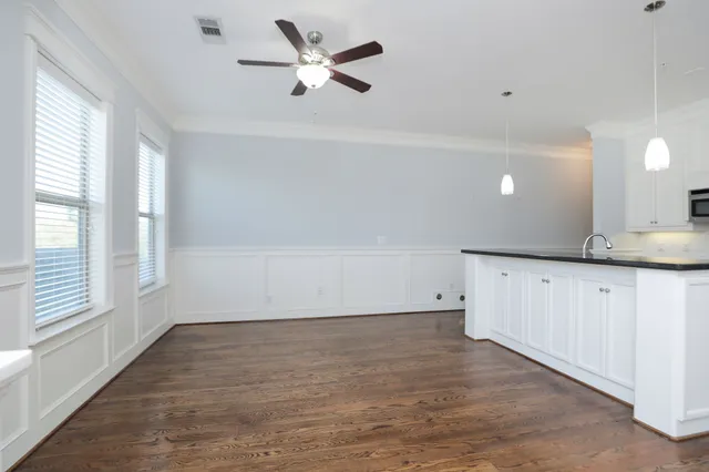 a kitchen with granite countertop a sink and cabinets