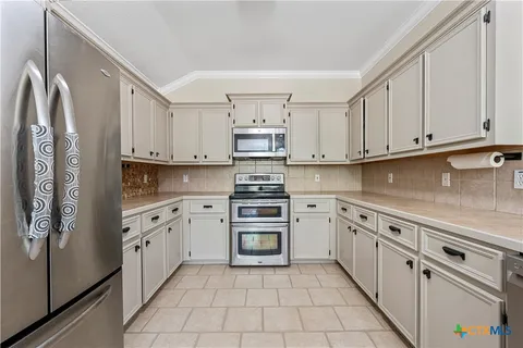 a kitchen with stainless steel appliances granite countertop a refrigerator sink and cabinets