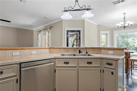 a kitchen with a sink and a refrigerator