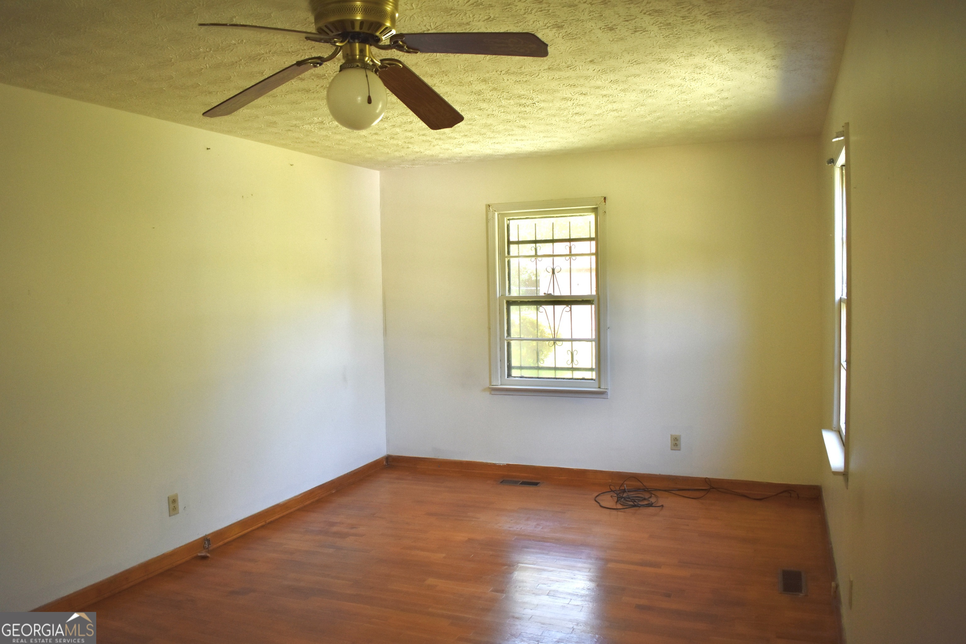 148 Upson Street Lexington, GA 30648 - Photo 2 of 12 a view of empty room with wooden floor