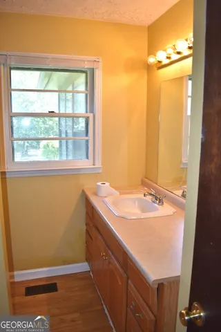 a bathroom with a sink and a window