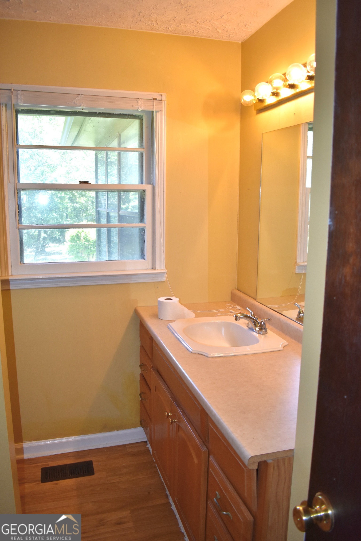 148 Upson Street Lexington, GA 30648 - Photo 3 of 12 a bathroom with a sink and a window