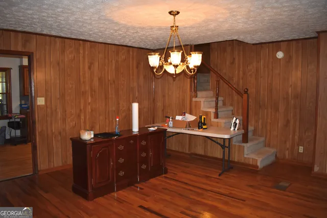 a view of a dining room with furniture wooden floor and chandelier