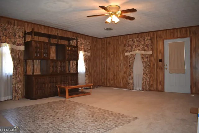 an empty room with windows and closet