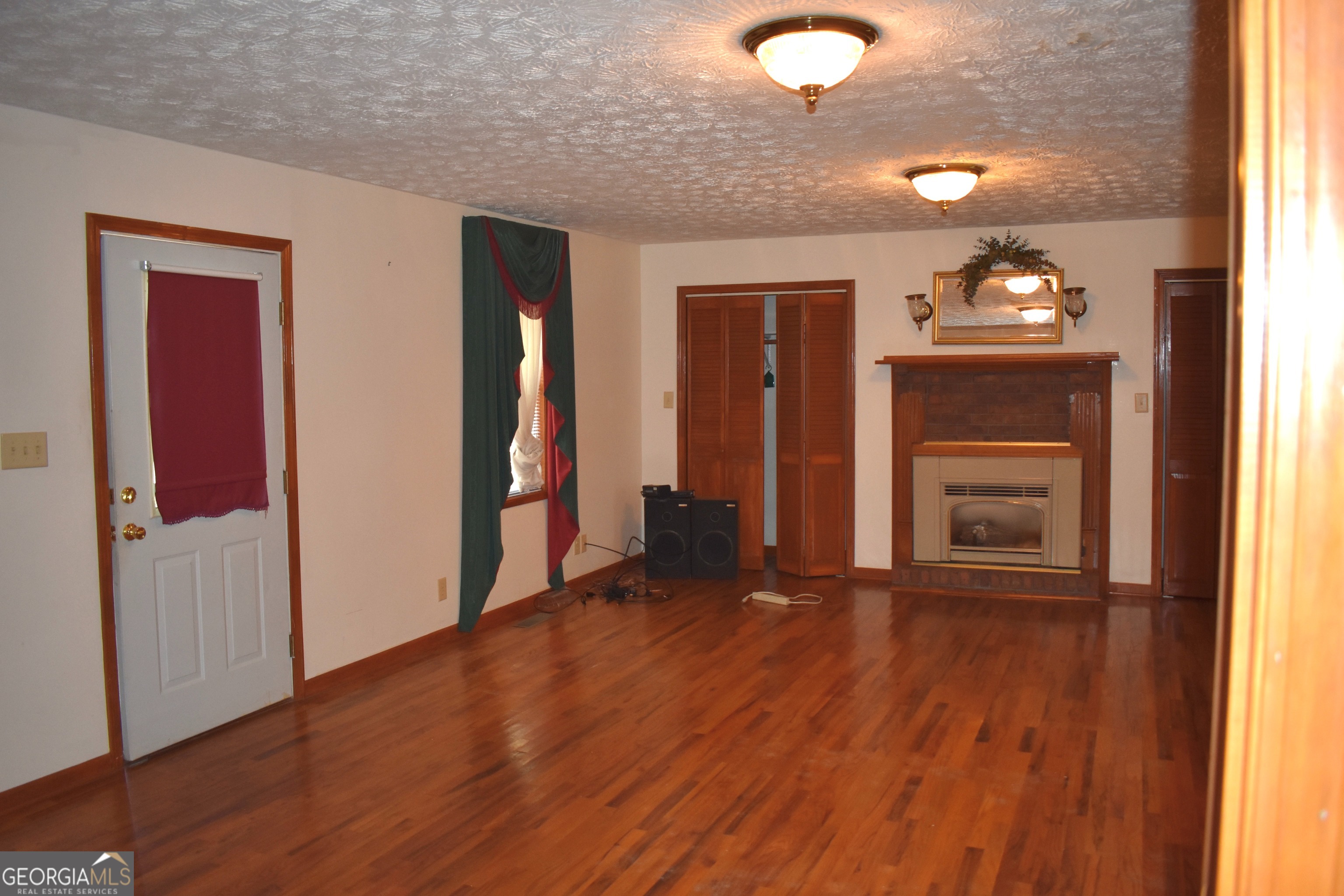148 Upson Street Lexington, GA 30648 - Photo 10 of 12 wooden floor in an empty room with a window