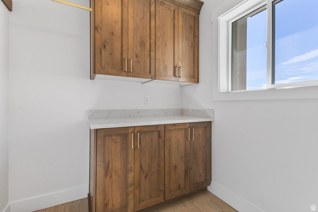 638 East Mountain Road North Ogden, UT 84414 - Photo 17 of 28 Bar featuring light stone countertops and brown cabinets
