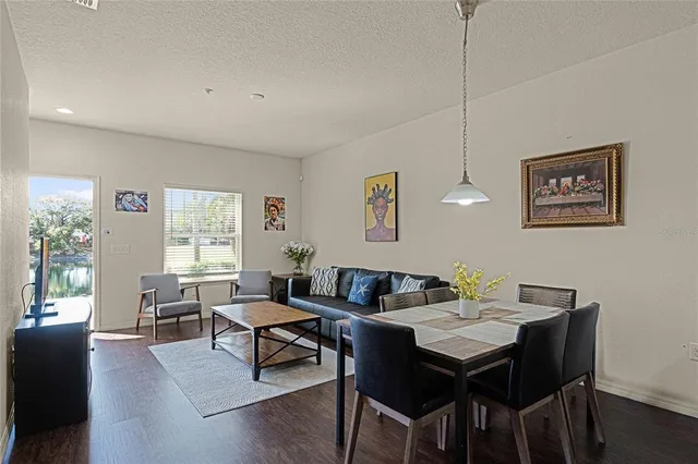 a living room with furniture two window and a table