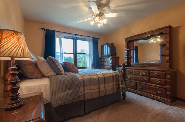 3087 Wagner Road Aurora, IL 60502 - Photo 16 of 20 a bedroom with a bed and a flat tv screen on dresser