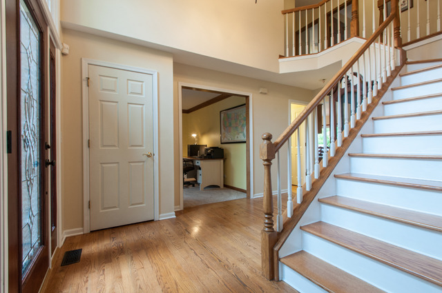3087 Wagner Road Aurora, IL 60502 - Photo 2 of 20 a view of an entryway with wooden floor and stairs