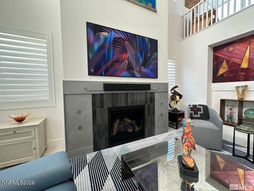 5545 Western Rider Trail Reno, NV 89511 - Photo 12 of 37 a living room with furniture a flat screen tv and a fireplace