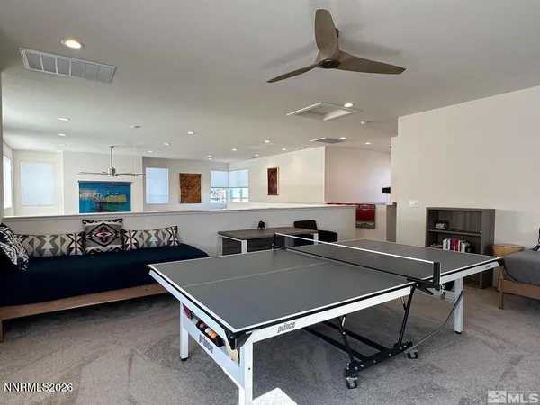 a kitchen with stainless steel appliances a stove a table and a refrigerator