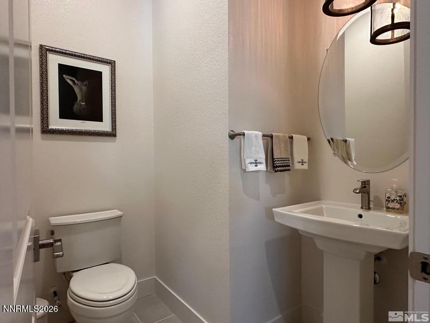 5545 Western Rider Trail Reno, NV 89511 - Photo 24 of 37 a bathroom with a toilet a sink and mirror