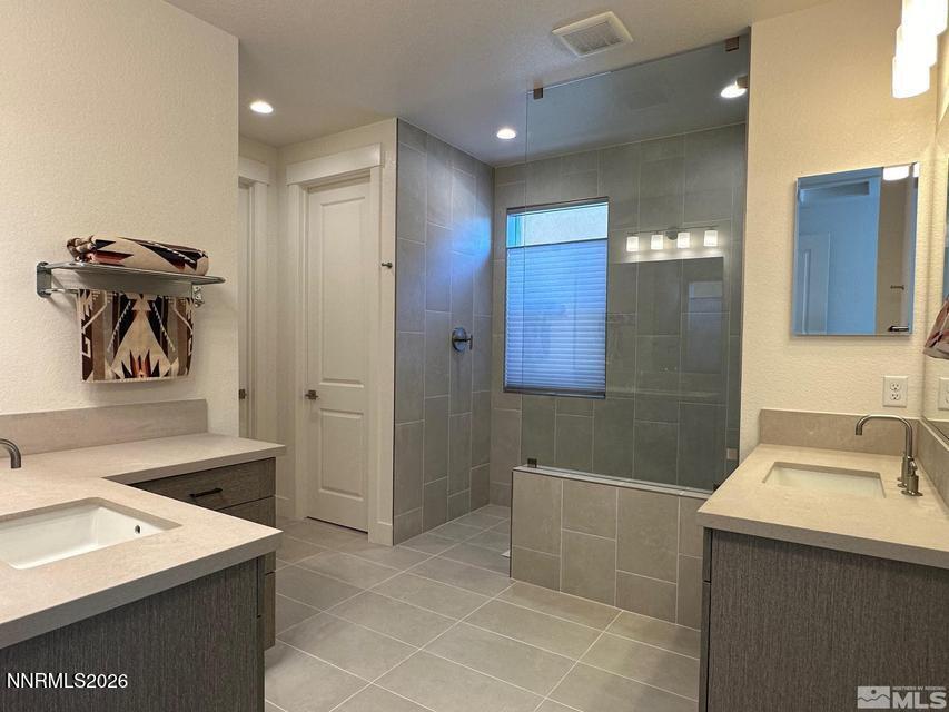 5545 Western Rider Trail Reno, NV 89511 - Photo 29 of 37 a bathroom with a sink a toilet and shower