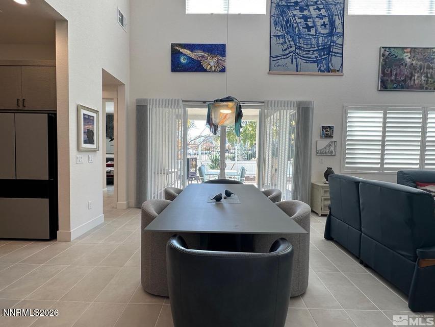 5545 Western Rider Trail Reno, NV 89511 - Photo 5 of 37 a dining room with wooden floor and large windows