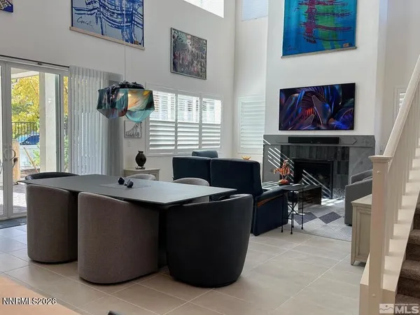 a view of a workspace with furniture and window