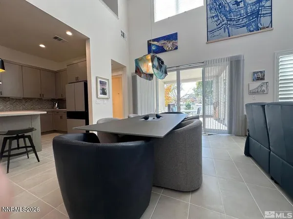 a kitchen with kitchen island granite countertop a refrigerator a sink and a stove