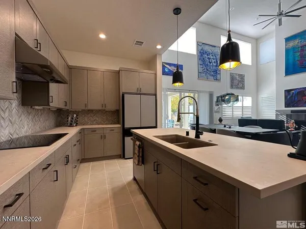 a kitchen with stainless steel appliances granite countertop a sink a stove and a refrigerator