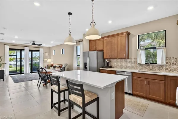 a kitchen with a dining table chairs sink and cabinets