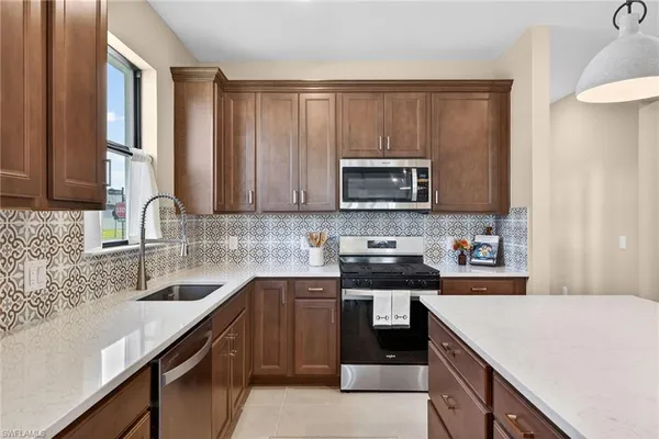 a kitchen with a sink stove top oven and cabinets
