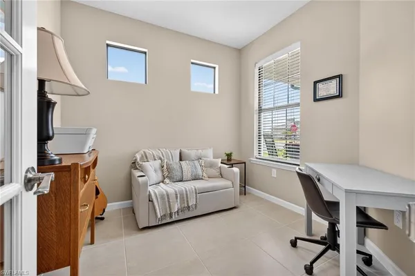 a living room with furniture a rug and a window