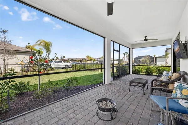 a view of a patio with table and chairs potted plants with wooden floor and fence