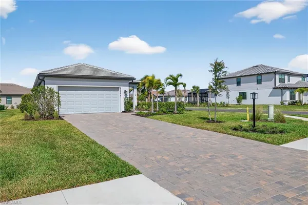 a front view of a house with a yard and garage