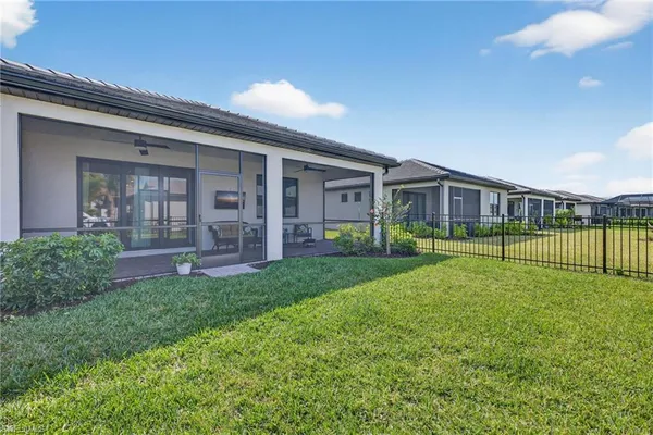 a view of a house with backyard and porch