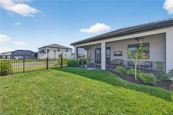a view of a house with backyard and a garden